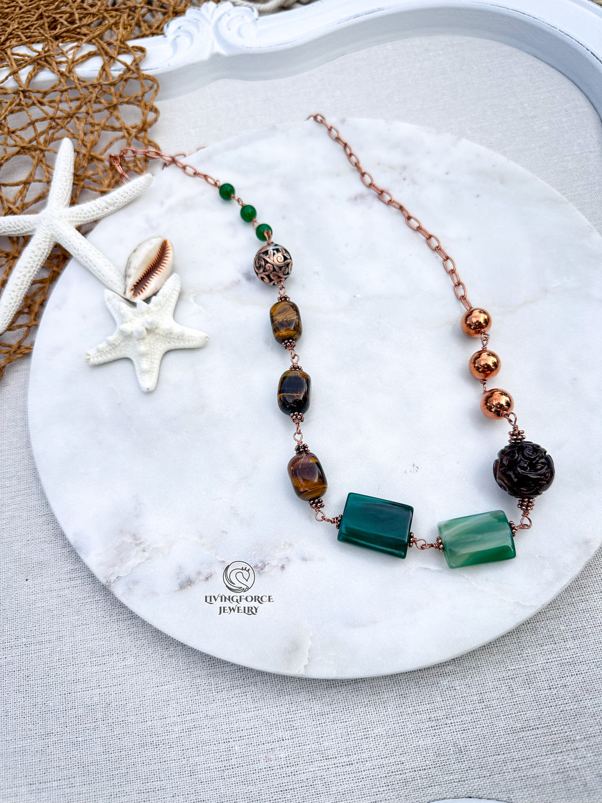 Green Terra Necklace

Jade, agate, and tiger eye in copper.