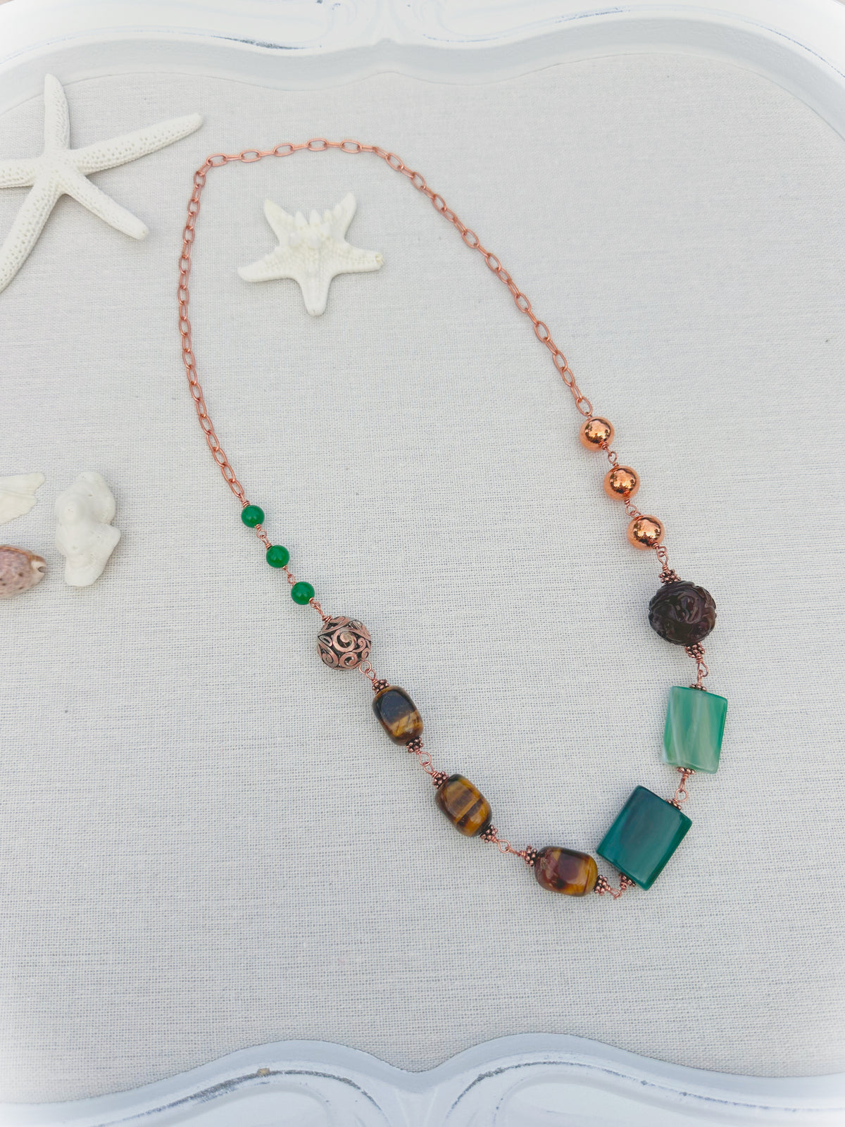 Green Terra Necklace

Jade, agate, and tiger eye in copper.